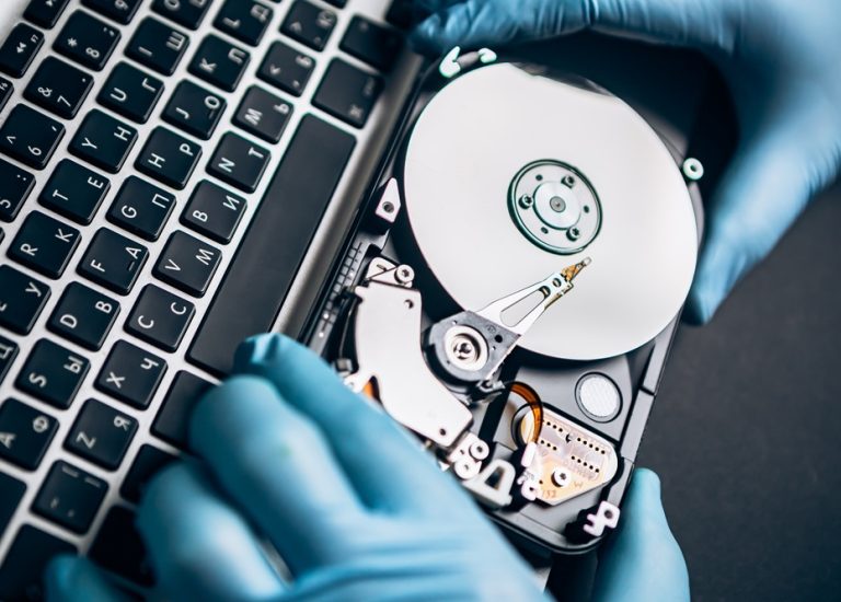 computer-service-engineer-technician-workplace-repairing-fixing-disassembled-hdd-hard-drive-data