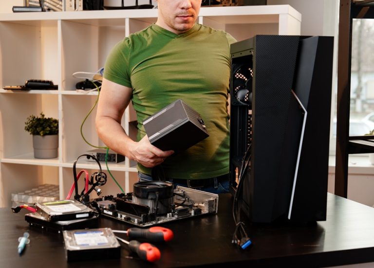 Man assembles a computer system unit at home close up